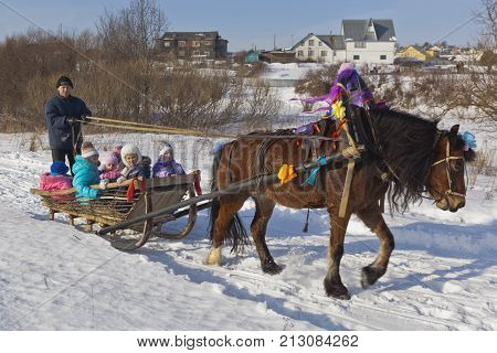 Verkhovazhye, Vologda region, Russia - March 1, 2014: Children ride in a sleigh horse Shrovetide