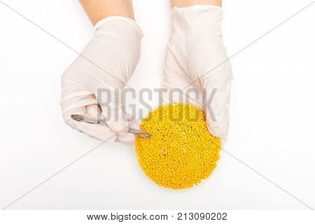 Plastic Pellets . Colorant For Polymers In Granules. Plastic Pellets In The Hands With Gloves And Tw