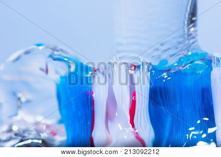 View of colorful tooth brush under water fall.