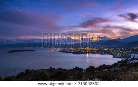 Panoramic high point view at sunset of the picturesque gulf of Mirambello, with the island of Agioi Pantes and the town of Agios Nikolaos, Crete, Greece