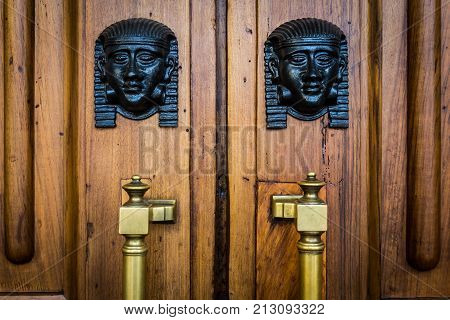 Sphinx Heads Entrance On Wooden Door
