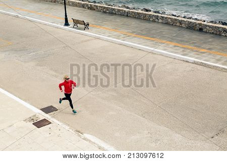 Woman Running On City Street At Seaside