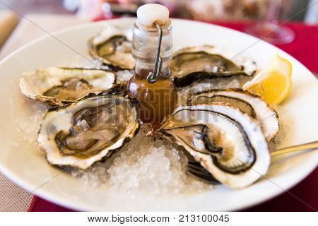 Oysters With Lemon On A Plate, Sete, France. Close-up.