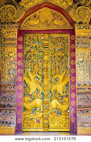Bas-relief On The Wall Of The Temple Wat Sensoukaram In Louangphabang, Laos. Vertical. Close-up.