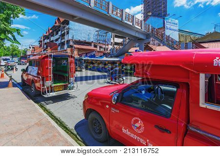 CHIANG MAI THAILAND - JULY 27: Red taxis waiting for people in the downtown area of Chiang mai on July 27 2017 in Chiang Mai