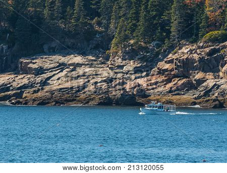 White Lobster Boat Along Rocky Maine Coast checks traps