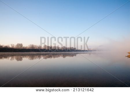 Morning on the river early morning reeds mist fog and water surface on the river