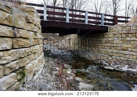 A bridge, along the Little Traverse Wheelway, which connects Charlevoix, Petoskey and Harbor Springs, Michigan, allows hikers and bicyclists to cross Tannery Creek.