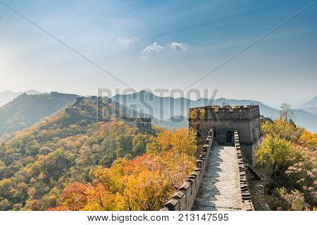 China The great wall distant view compressed towers and wall segments autumn season in mountains near Beijing ancient chinese fortification military landmark in Beijing China.