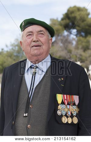Aubagne, France. May 11, 2012. Portrait of a veteran of the French Foreign Legion in a green beret in a jacket with military medals during the annual meeting of veterans.