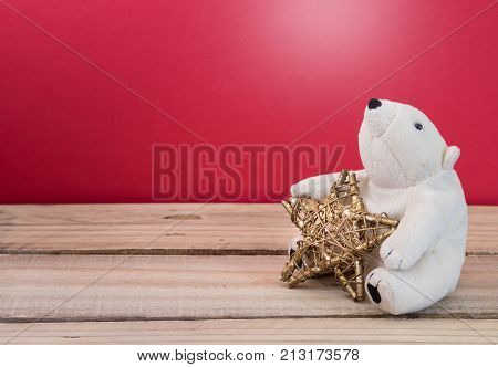 Christmas gold star with fluffy polar bear toy. Christmas holiday celebration concept.