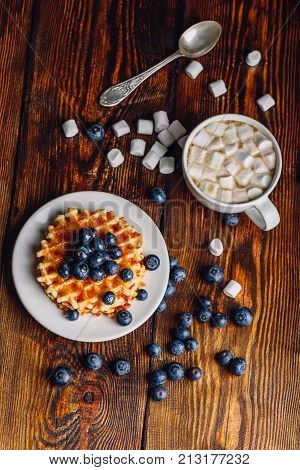 Waffles with Fresh Blueberry and Honey on Plate, Cup of Coffee with Marshmallow.Vertical Orientation.
