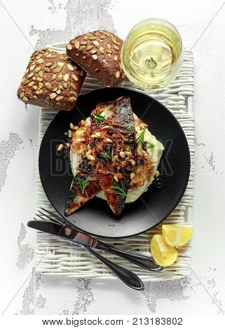 Sicilian style mackerel on cauliflower puree with caramelized onions, pine nuts served with rustic bread and white wine.