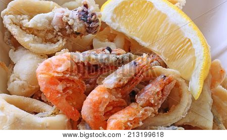 fried fish with shrimp and seafood at the takeaway restaurant and a lemon slice