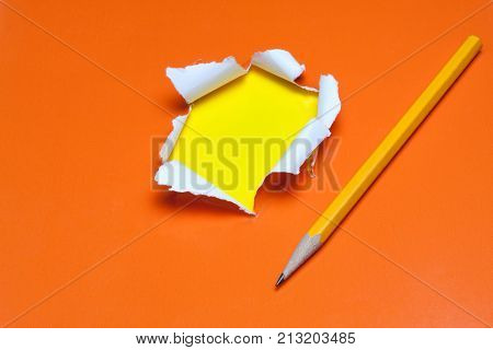 Torn Orange Paper Hole. Tearing Inside Yellow