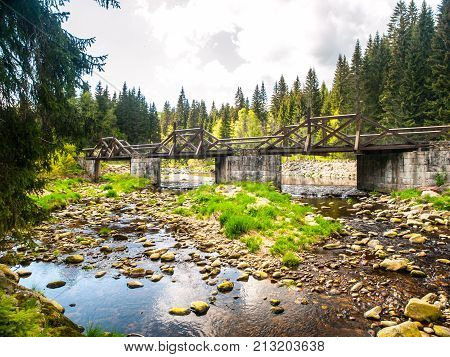 Wooden Soumarsky bridge over Vydra mountain river, Sumava National Park, Czech Republic.