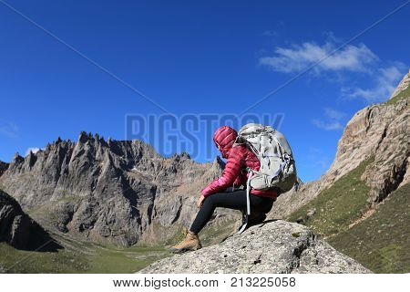 woman with backpack hiking in mountains travel lifestyle success concept adventure active vacations outdoor mountaineering sport sunrise landscape