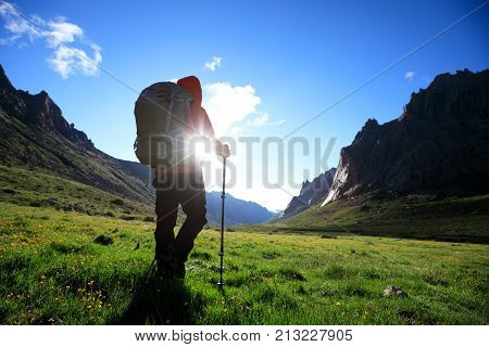 woman with backpack hiking in mountains travel lifestyle success concept adventure active vacations outdoor mountaineering sport sunrise landscape