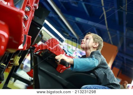 Kid Playing In Motorcycle Simulator