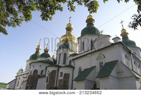 St. Sophia Cathedral in Kiev. Monument of ancient architecture on a summer day. St. Sophia Cathedral in Kiev. A monument of ancient architecture on a summer day against the sky. Golden domes. bottom view