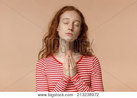 Indoor Portrait Of Young Beautiful European Woman With Red Curly Hair Isolated On Peach Background P