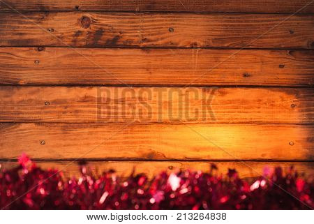 Red tinsel on wooden background, Christmas background
