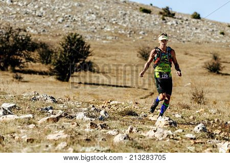 Crimea Russia - October 11 2017: athlete runner leader of marathon running on mountain trail during Crimea Х Run