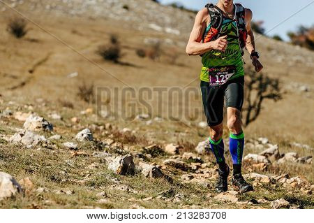 Crimea Russia - October 11 2017: man athlete runner running on mountain trail during Crimea Х Run