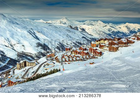 Stunning winter landscape and ski resort with typical alpine wooden houses in French Alps, Les Menuires, 3 Vallees, France, Europe