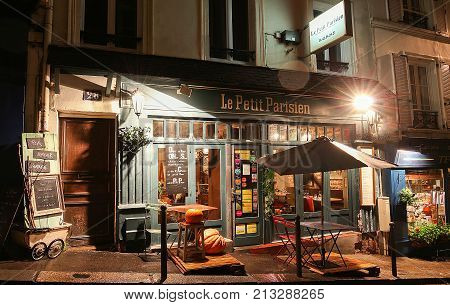 PARIS , France- November 11, 2017: View of typical paris cafe in Paris. Montmartre area is among most popular destinations in Paris, Le Petit Parisien is a typical cafe.