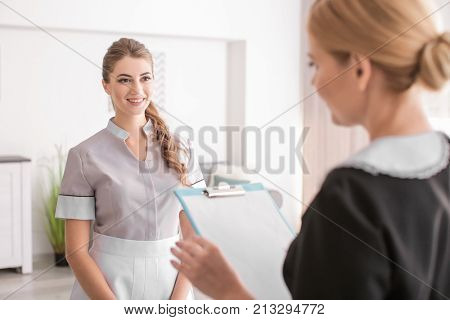Chambermaid and trainee in room