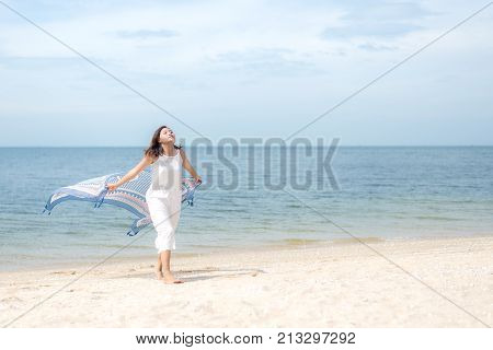 Freedom aisan young women jumping and happy on the suumer beach. Travel and Vacation. Freedom & Lifestyle Concept