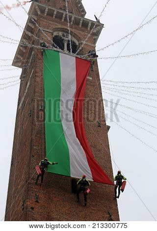 Vicenza, Vi, Italy - December 4, 2015: Firefighters With A Big Italian Flag And The Tower