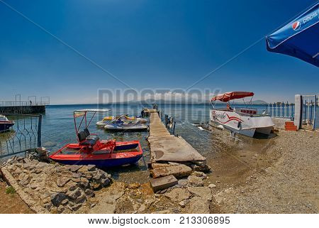 SEVAN LAKE, ARMENIA - 02 AUGUST 2017: Beach and Watersports Boats at Mountain Lake of Sevan in Armenia