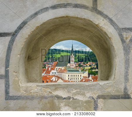 Church of St. Vitus seen through the embrasure of the castle in Krumlov in Czech Krumlov in the Czech Republic in September