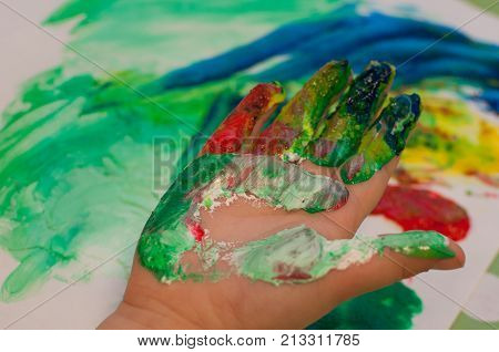 children painting with finger paint on white paper