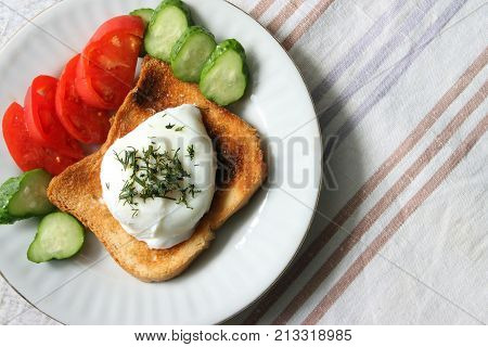 Breakfast. Egg poached and vegetables on a plate.