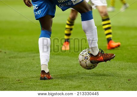 SOLNA SWEDEN - OCT 30 2017: Closeup of legs of soccer players fighting to get the ball in the game AIK and IFK Gothenburg. October 30 2017SolnaSweden