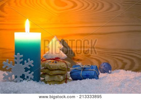 Avent candle and Christmas cookies isolated on wood background.