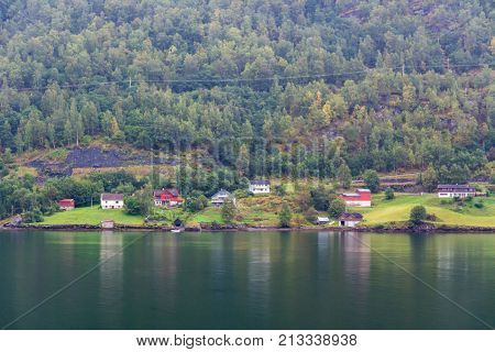 Flam is a village in Flamsdalen at the inner end of the Aurlandsfjorden a branch of Sognefjorden. The village is located in the municipality of Aurland in Sogn og Fjordane county Norway.