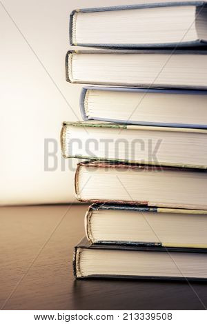 stack of old books on a table to the library.