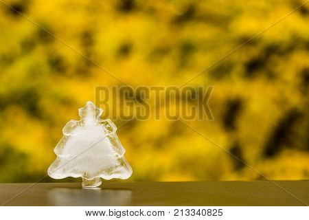 Winter is coming. Christmas tree ice decoration on autumn outside