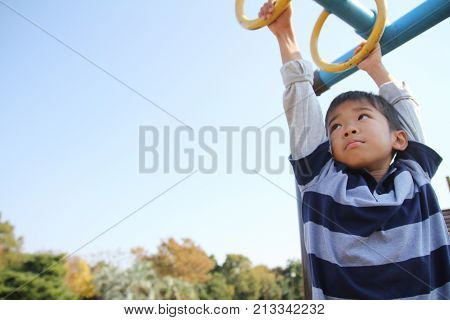 Japanese Boy Playing With A Monkey Bars (second Grade At Elementary School)