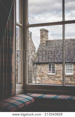 Tartan Curtains And Cushions On A Window Seat In An Old Country Scottish Village. Shot From Indoors