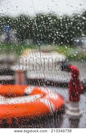 Orange life preserver on a boat during a rain storm shallow depth of field