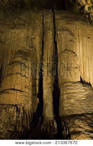 Vertical view of the amazing cavern speleothems mostly stalactite stalagmite formations with warm lighting at the Luray Caverns, Virginia located in the Shenandoah Valley.