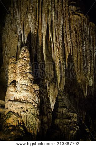 Vertical close up view of the amazing cavern speleothems mostly stalactite stalagmite formations with warm lighting at the Luray Caverns, Virginia located in the Shenandoah Valley.