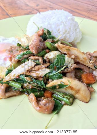 Thai Spicy Food Basil Pork Fried Rice Recipe (krapao Gai) With Fried Egg In Green Plate On Wooden Ba