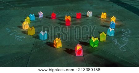 Paper lanterns forming heart shape on a cobblestone road