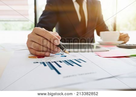 Business Analysts Work With Income Documents At His Office, Digital Tablet And Calculator On Desk, B